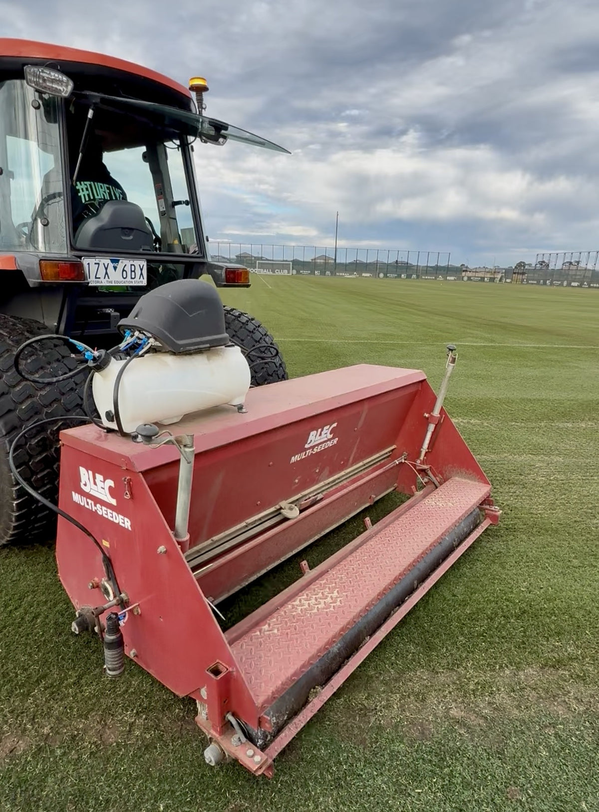 Tractor-mounted BLEC Multi-Seeder showing the seed hopper and rear roller