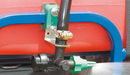 Boomless nozzle kit installed on a sprayer, showing a single green nozzle