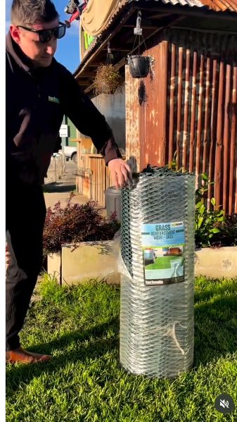 A Turfmate team member with a roll of grass reinforcement mesh in our reel.